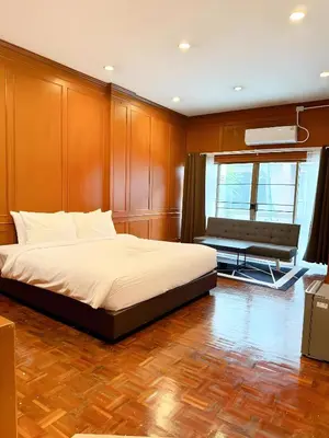 a bedroom with a bed and a bench in it at Stay On Sukhumvit Soi 11 - สเตย์ ออน สุขุมวิท 11 in Makkasan