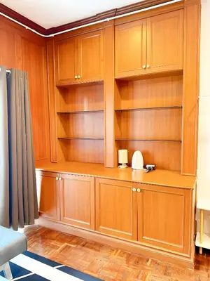 a room with wooden cabinets and shelves at Stay On Sukhumvit Soi 11 - สเตย์ ออน สุขุมวิท 11 in Makkasan