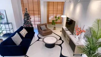 a living room with a christmas tree and a television at Private Pool Villas Sukhumvit 26 Near BTS Phrom Phong and EmSphere in Bangkok
