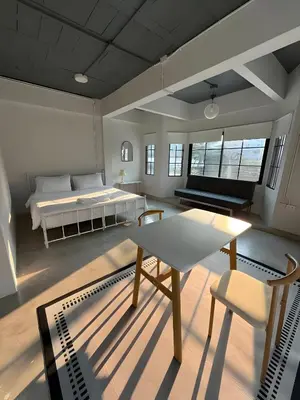 a room with a bed and a table and a couch at xx Yellow Place Sukhumvit Soi 2 BTS Nana - เยลโล เพลส สุขุมวิท ซอย 2 บีทีเอส นานา in Bang Kapi