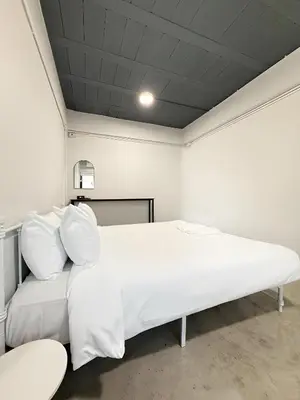 a bedroom with a white bed and a couch at xx Yellow Place Sukhumvit Soi 2 BTS Nana - เยลโล เพลส สุขุมวิท ซอย 2 บีทีเอส นานา in Bang Kapi