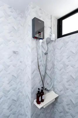 a shower in a bathroom with a white tiled wall at xx Yellow Place Sukhumvit Soi 2 BTS Nana - เยลโล เพลส สุขุมวิท ซอย 2 บีทีเอส นานา in Bang Kapi