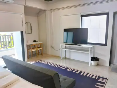 a living room with a couch and a tv at xx Yellow Place Sukhumvit Soi 2 BTS Nana - เยลโล เพลส สุขุมวิท ซอย 2 บีทีเอส นานา in Bang Kapi