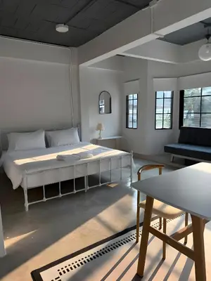 a bedroom with a large bed and a table at xx Yellow Place Sukhumvit Soi 2 BTS Nana - เยลโล เพลส สุขุมวิท ซอย 2 บีทีเอส นานา in Bang Kapi