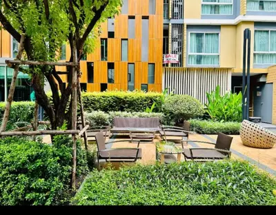 a patio with chairs and tables and a building at Welcome to warm room here have gym saona Netflix in Bangkok