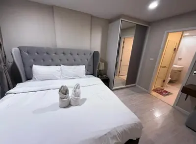 a pair of shoes sitting on top of a bed at Welcome to warm room here have gym saona Netflix in Bangkok