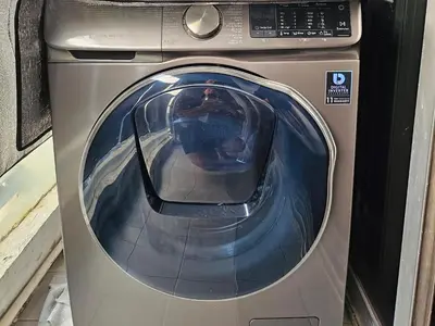 a washing machine is sitting in a room at Kuma House Sukhumvit in Bangkok
