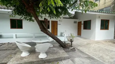 a bathroom with toilets next to a tree at Baan Yard - More than 5 nights stay in Bangkok