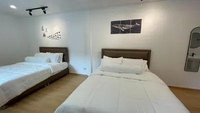 two beds sitting next to each other in a room at Baan Yard - More than 5 nights stay in Bangkok