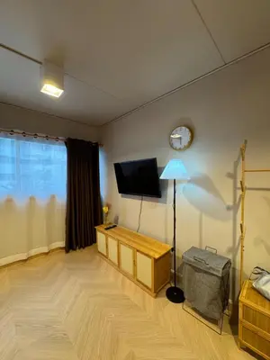 a living room with a flat screen tv on the wall at MoonStay C5 Impactarena-Donmuang-FreeSpeedWifi in Thung Si Kan