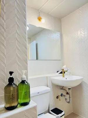 a bathroom with a sink and a toilet and a mirror at MoonStay C1 Impact Arena Muangthongthani-Donmuang-FreeSpeedWifi in Nonthaburi
