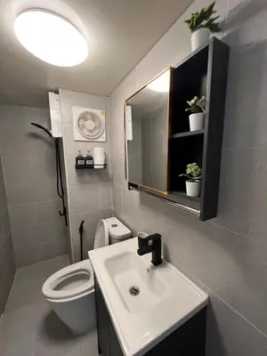 a bathroom with a sink and a toilet and a mirror at Lazy House at Impact Muangthong in Thung Si Kan