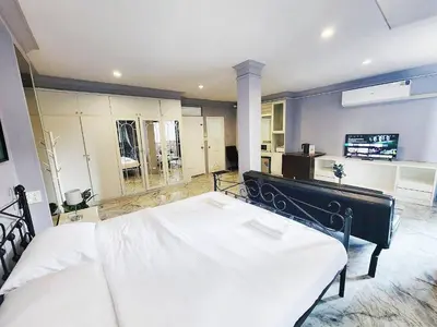 a bedroom with a large bed in a room at Cozy Private Family Apartment in Bangkok CBD Silom-Sathorn - 240m to BTS Saint Louis in Yan Nawa