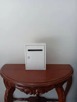 a wooden table with a white box on top of it at HD China Town MRT Dragon Temple กลางเยาวราช in Bangkok