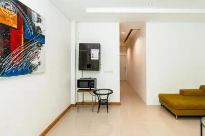 a hallway with a couch and a table in a room at XX YON INN Sukhumvit 4 Bangkok - BTS Nana in Bang Kapi