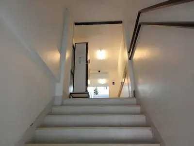 a stairway leading up to a door in a building at XX Wish Inn Chidlom - วิช อินน์ ชิดลม in Bangkok
