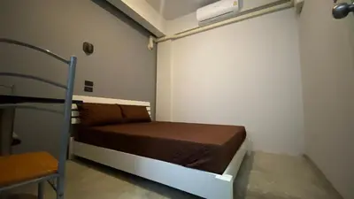 a bedroom with a bed in a room with a bed gmaxwell gmaxwell gmaxwell at Capricorn hostel Yaowarat in Chinatown