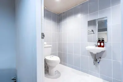 a bathroom with a toilet and a sink at xx Stay On Sukhumvit Soi 11 สเตย์ออน สุขุมวิท 11 in Makkasan