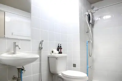 a bathroom with a toilet and a sink and a shower at xx Stay On Sukhumvit Soi 11 สเตย์ออน สุขุมวิท 11 in Makkasan