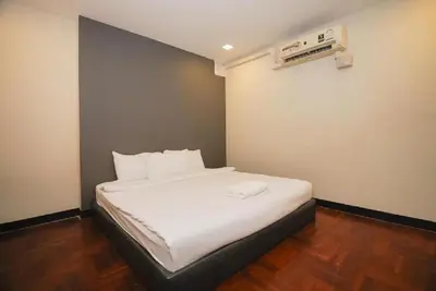 a bedroom with a bed with white sheets at XX GO INN Silom BTS Surasak สถานีสุรศักดิ์ in Yan Nawa