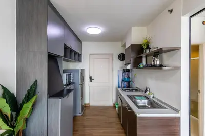 a small kitchen with a sink and a refrigerator at TC Contel At True Digital Park in Amphoe Phra Khanong