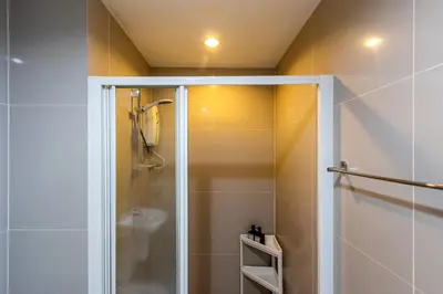 a shower with a glass door in a bathroom at TC Contel At True Digital Park in Amphoe Phra Khanong