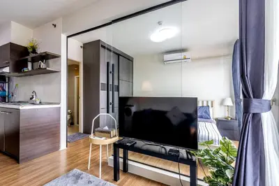 a living room with a large flat screen tv at TC Contel At True Digital Park in Amphoe Phra Khanong