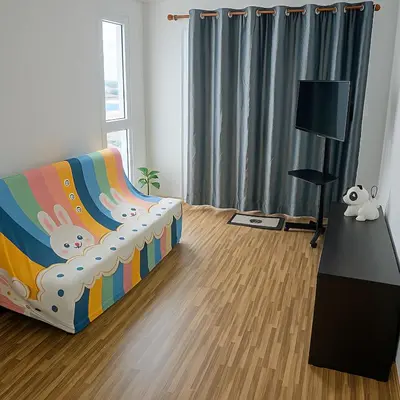 a living room with a couch and a table at Laid back at IRIS Westgate Bangkok-Nonthaburi in Ban Bang Phai