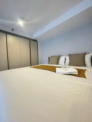 a bedroom with two large beds with white sheets at City Lights Retreat in Bangkok