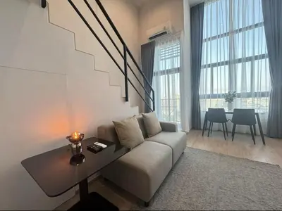 a living room with a couch and a table at City Lights Retreat in Bangkok