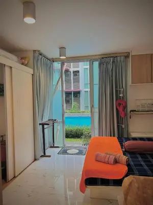 a bedroom with an orange bed and a sliding glass door at Modern Condo with Full Amenities Bangkok in Sathani Ban Hua Mak