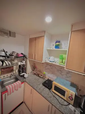 a small kitchen with a sink and a microwave at Modern Condo with Full Amenities Bangkok in Sathani Ban Hua Mak