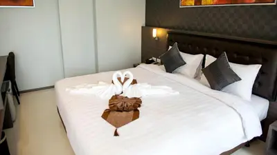 a bed with two white bows on it at Picnic Hotel Bangkok - Rang Nam in Bangkok