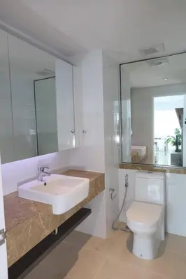 a bathroom with a sink and a toilet and a mirror at Lummpni palace in Ban Bang Toei (1)