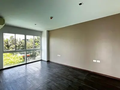 an empty room with a large window and a tile floor at Lummpni palace in Ban Bang Toei (1)