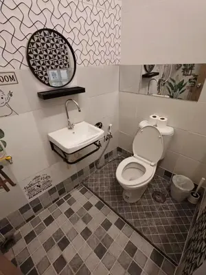 a bathroom with a toilet and a sink at Charoen Nakhon 48 House in Godown