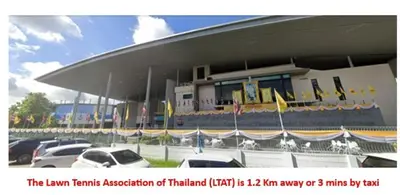 a large building with cars parked in a parking lot at Cozy 2BR for 4 persons, Impact,Wi-Fi & Washer, DMK in Bangkok