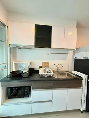 a small kitchen with a sink and a microwave at Supalai Wellington 2 Near MRT in Bangkok