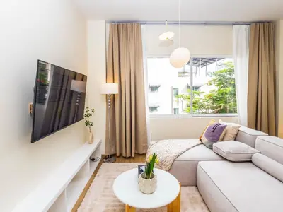 a living room with a white couch and a window at 2 Bedroom for 3 guests in heart Sathorn with Balcony in Bangkok