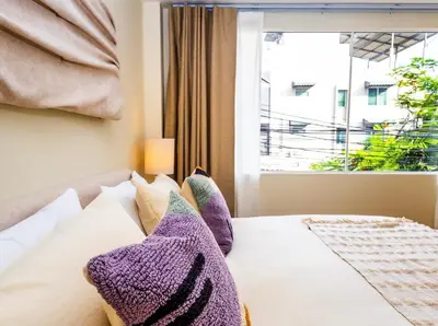 a bedroom with a bed with a window at 2 Bedroom for 4 guests Private in center of Sathorn in Bangkok
