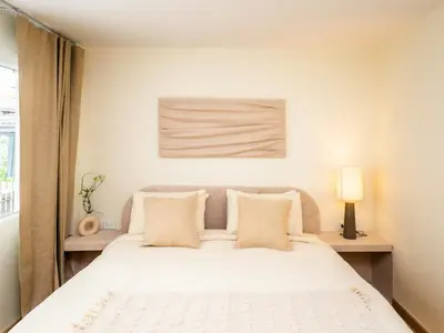a bedroom with a white bed with two pillows at 2 Bedroom for 4 guests Private in center of Sathorn in Bangkok
