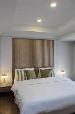 a large white bed in a room with two lamps at Bangkok Place Apartment - EKAMAI BTS in Bangkok
