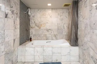 a white tub in a bathroom with a shower at NEW Bangkok centre-2 bedrooms Netflix 31 floor in Bangkok