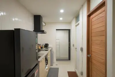 a kitchen with a sink and a counter top at LumiLoft in Bangkok
