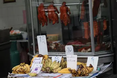 a bunch of bananas on a table with signs at SKY 10 Convenient near Lumphini Park and MRT in Bangkok