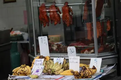 a bunch of bananas on a table with signs at SKY 14 Vibrant street Cozy n Cool near center in Bangkok
