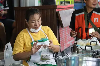 a woman with a bandage on her face eating food at SKY 18 - 99 feet in the sky in Bangkok