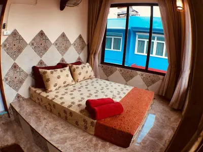 a bed sitting in a room with a window at SKY 18 - 99 feet in the sky in Bangkok