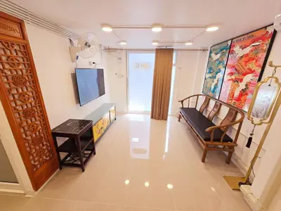 a living room with a couch and a tv in it at Crane nest 1 Easy-peasy no stairs in Bangkok