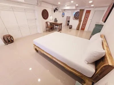 a bedroom with a large bed in a room at Crane nest 1 Easy-peasy no stairs in Bangkok